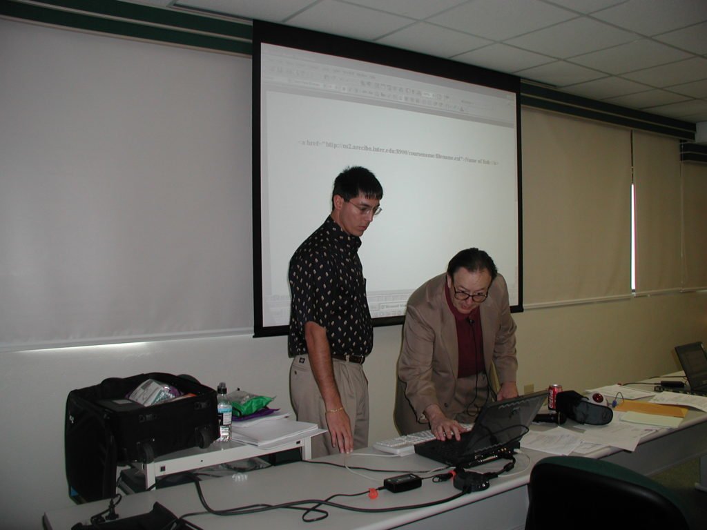 CW preparing PC for co-teaching presentation at training program for Universidad Interamericana de Puerto Rico